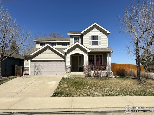 view of front of house featuring stone siding, covered porch, concrete driveway, fence, and an attached garage
