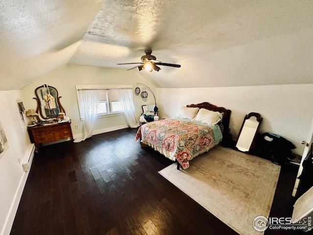 506 E 1st Ave, Otis, CO 80743 - bedroom featuring a baseboard radiator, vaulted ceiling, wood finished floors, and a textured ceiling