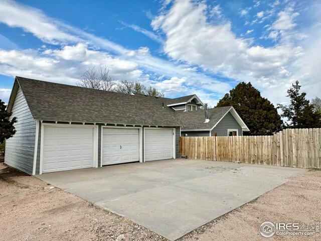 506 E 1st Ave, Otis, CO 80743 - garage with fence and driveway