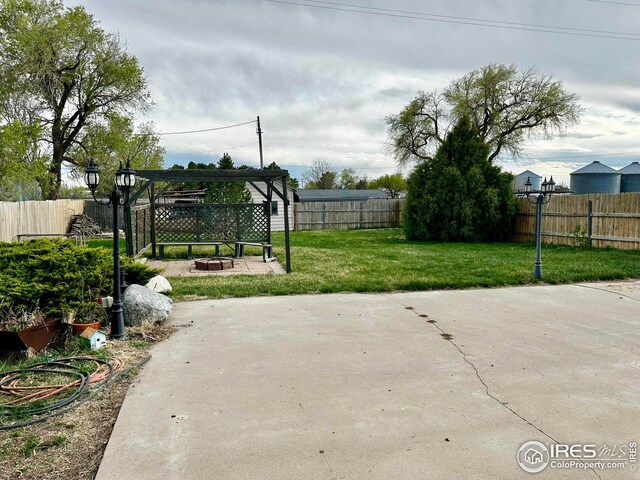 506 E 1st Ave, Otis, CO 80743 - view of patio with a fenced backyard and an outdoor fire pit