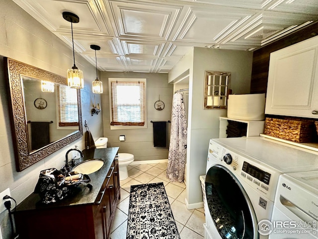 506 E 1st Ave, Otis, CO 80743 - bathroom featuring tile patterned flooring, toilet, vanity, independent washer and dryer, and an ornate ceiling