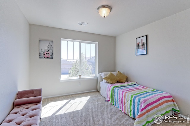 bedroom with baseboards, visible vents, and carpet