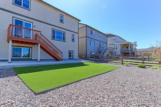 back of house with fence private yard, a patio, and stairway