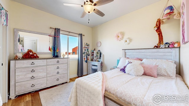 bedroom with a ceiling fan and light wood-style flooring