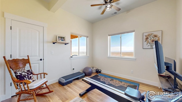 exercise area featuring ceiling fan, baseboards, wood finished floors, and visible vents