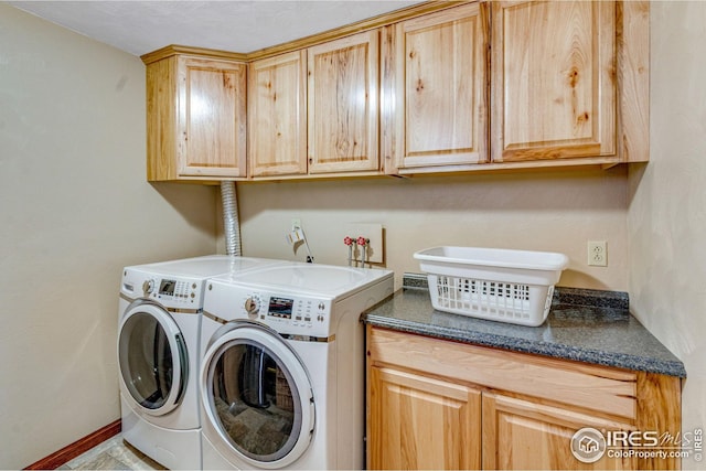 washroom with washing machine and clothes dryer and cabinet space