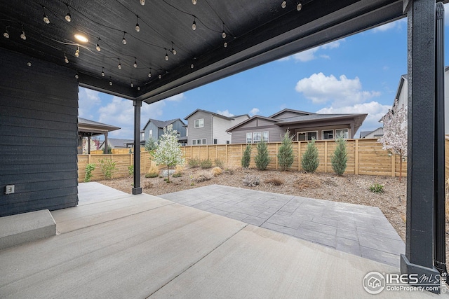 view of patio / terrace featuring a fenced backyard and a residential view