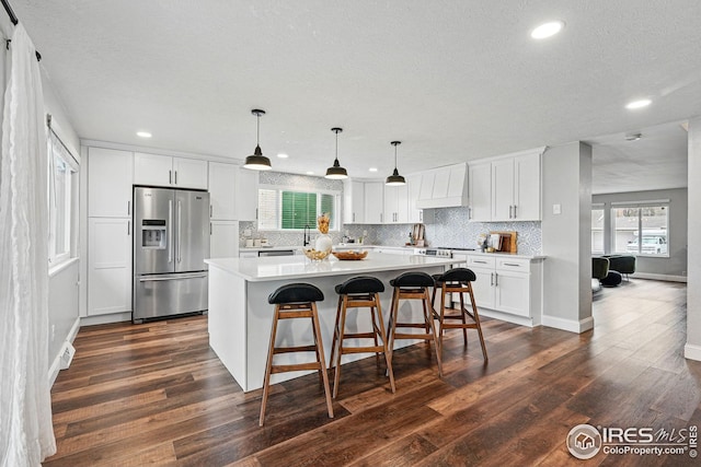 9601 Sierra Dr, Arvada, CO 80005 - kitchen with stainless steel refrigerator with ice dispenser, recessed lighting, and backsplash