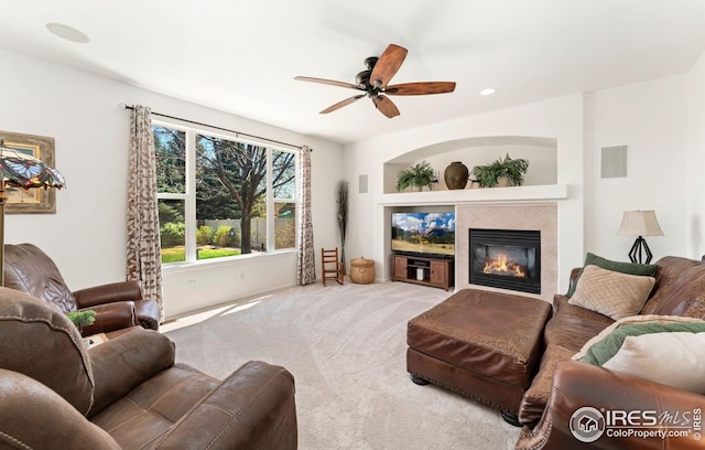carpeted living room featuring recessed lighting, a tile fireplace, and a ceiling fan