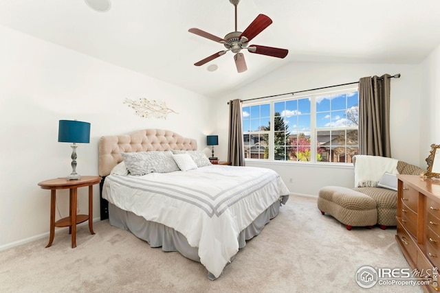 bedroom with baseboards, vaulted ceiling, ceiling fan, and light carpet
