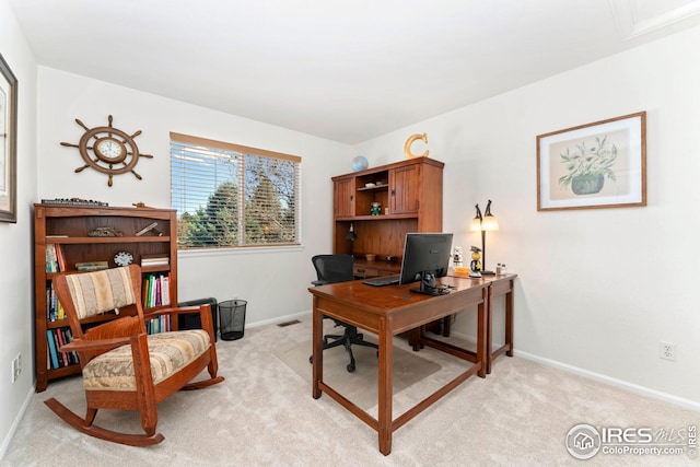 office featuring visible vents, baseboards, and light carpet