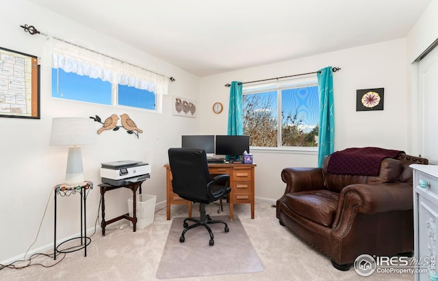 office with light colored carpet, baseboards, and plenty of natural light