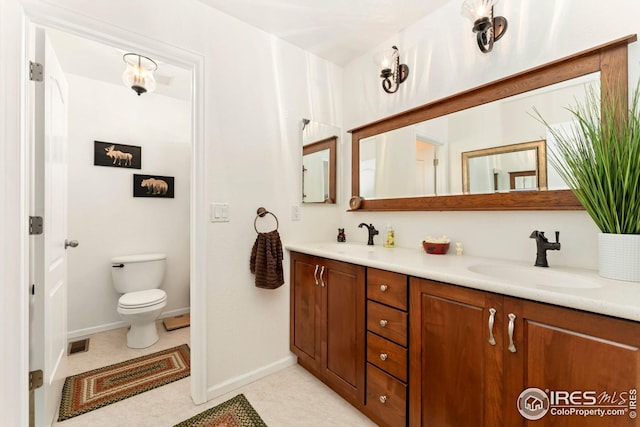 full bathroom with baseboards, visible vents, a sink, and double vanity