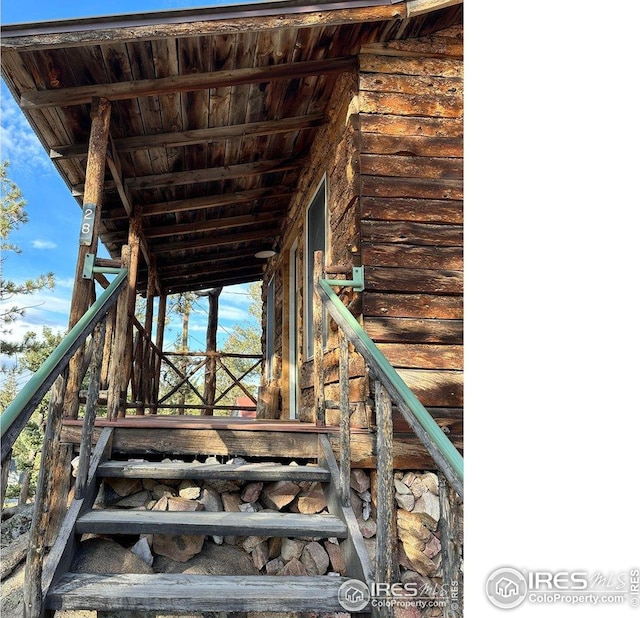 wooden terrace featuring an exterior structure