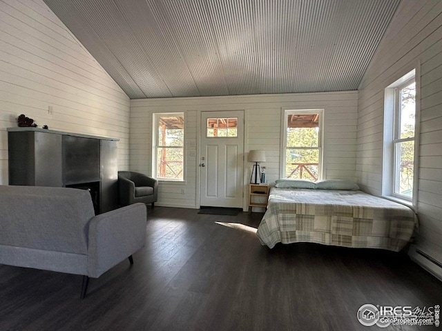 bedroom featuring high vaulted ceiling, a baseboard radiator, wood walls, and dark wood-type flooring