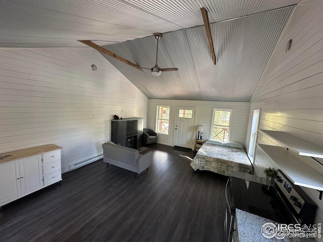 bedroom with wooden walls, dark wood-style floors, high vaulted ceiling, and baseboard heating