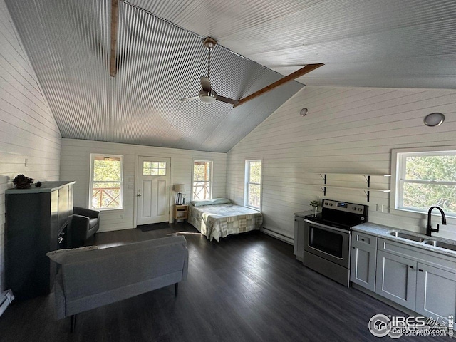 bedroom featuring high vaulted ceiling, wood walls, dark wood-style floors, and a sink