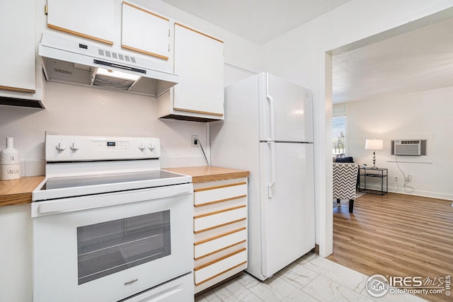 kitchen with under cabinet range hood, white appliances, light countertops, white cabinetry, and a wall unit AC