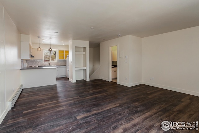 1733 Azalea Dr Unit 2, Fort Collins, CO 80526 - unfurnished living room featuring baseboards, a baseboard radiator, and dark wood finished floors