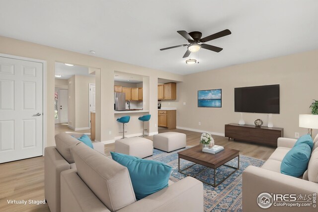 2930 W Stuart St Unit 27, Fort Collins, CO 80526 - living room featuring light wood-style flooring, ceiling fan, and baseboards