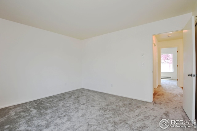 carpeted empty room with baseboards and baseboard heating