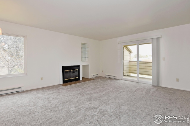 unfurnished living room featuring a fireplace with flush hearth, a baseboard radiator, and carpet