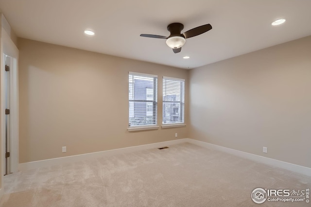 empty room with recessed lighting, a ceiling fan, and light carpet