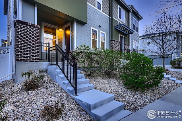 view of exterior entry with brick siding
