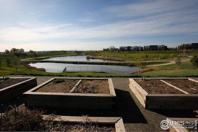 view of yard featuring a garden and a water view