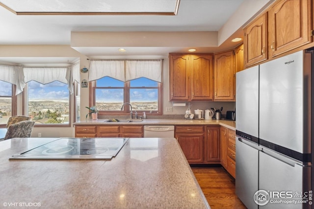 16261 W Ellsworth Ave, Golden, CO 80401 - kitchen with freestanding refrigerator, a sink, black electric stovetop, dishwasher, and light countertops