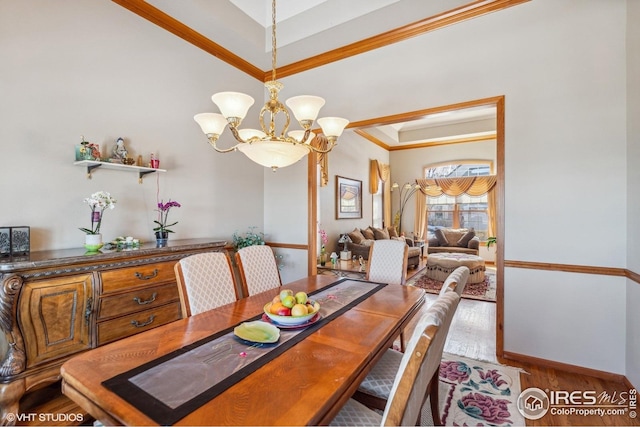16261 W Ellsworth Ave, Golden, CO 80401 - dining space with wood finished floors, a chandelier, ornamental molding, and baseboards