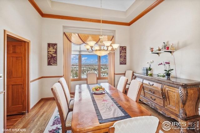 16261 W Ellsworth Ave, Golden, CO 80401 - dining room with a chandelier, wood finished floors, a tray ceiling, ornamental molding, and baseboards