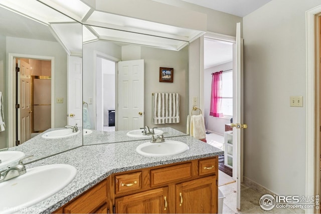 16261 W Ellsworth Ave, Golden, CO 80401 - full bathroom featuring double vanity, tile patterned floors, and baseboards