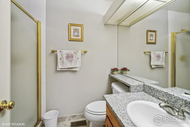 16261 W Ellsworth Ave, Golden, CO 80401 - full bathroom featuring toilet, an enclosed shower, vanity, baseboards, and tile patterned floors