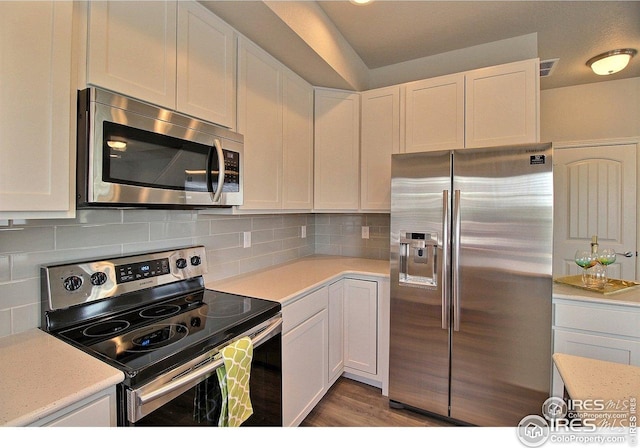 kitchen featuring light countertops, visible vents, white cabinetry, and appliances with stainless steel finishes