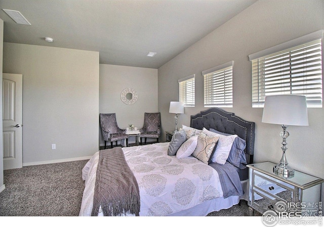 carpeted bedroom with visible vents and baseboards