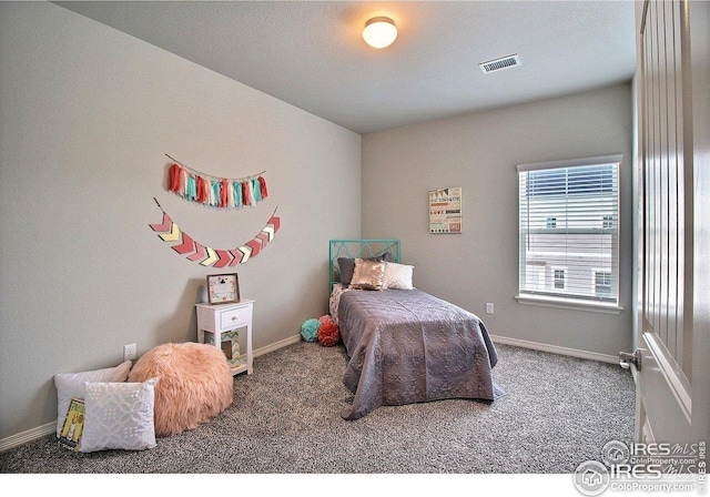 bedroom with visible vents, carpet flooring, and baseboards