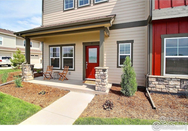 view of exterior entry with covered porch