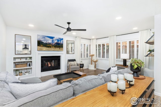 living area with ceiling fan, wood finished floors, and recessed lighting
