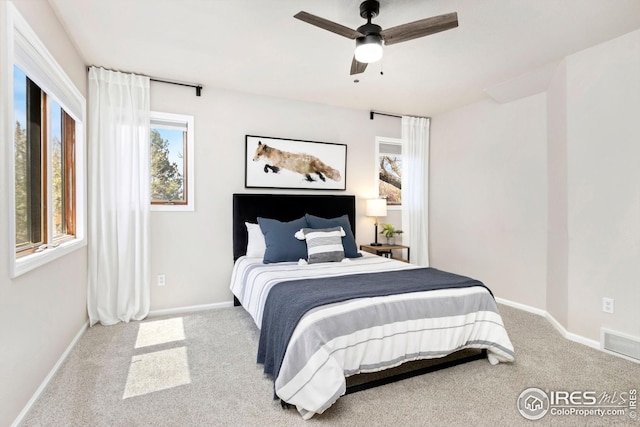 bedroom with baseboards, a ceiling fan, carpet flooring, and visible vents