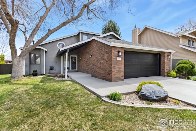 view of front of house featuring a garage, a front yard, brick siding, and a chimney