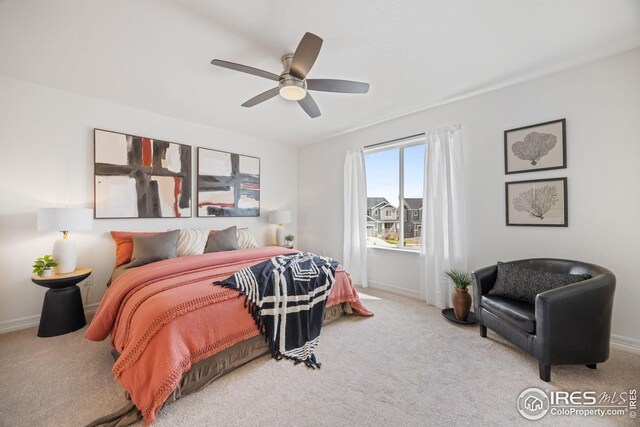 carpeted bedroom featuring ceiling fan and baseboards