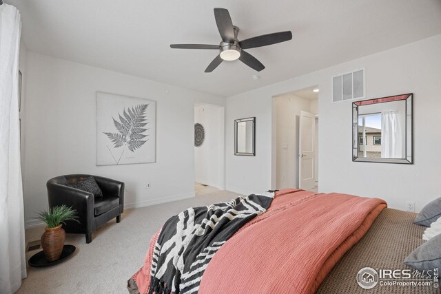 carpeted bedroom featuring visible vents, a ceiling fan, and baseboards