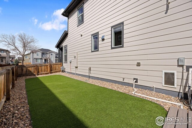 view of yard with a fenced backyard and a residential view
