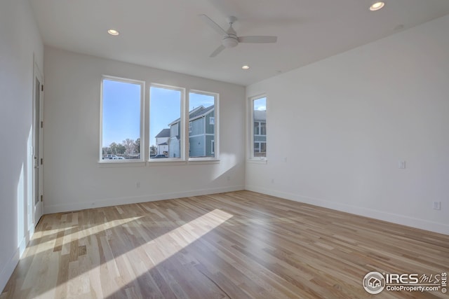 unfurnished room featuring baseboards, light wood-type flooring, ceiling fan, and recessed lighting