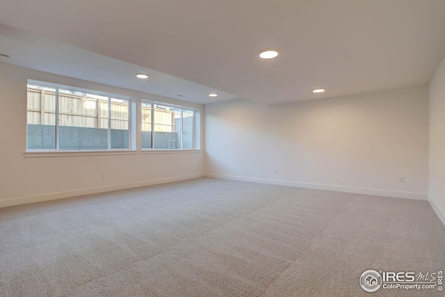 carpeted spare room featuring recessed lighting and baseboards