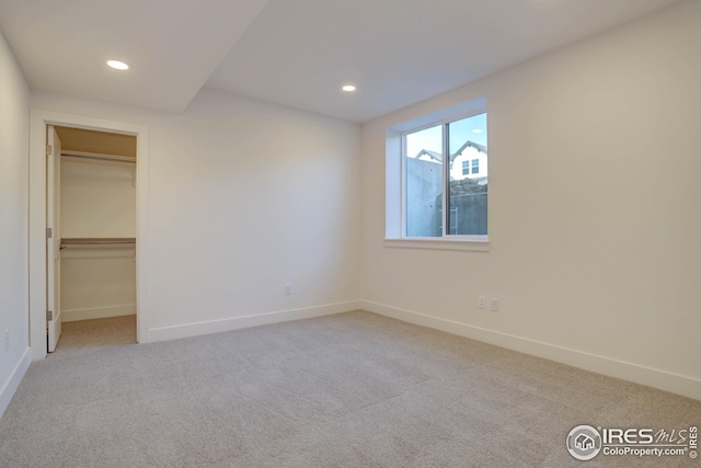 unfurnished bedroom featuring baseboards, recessed lighting, and carpet flooring