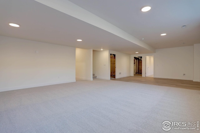 finished basement with light colored carpet, recessed lighting, and baseboards