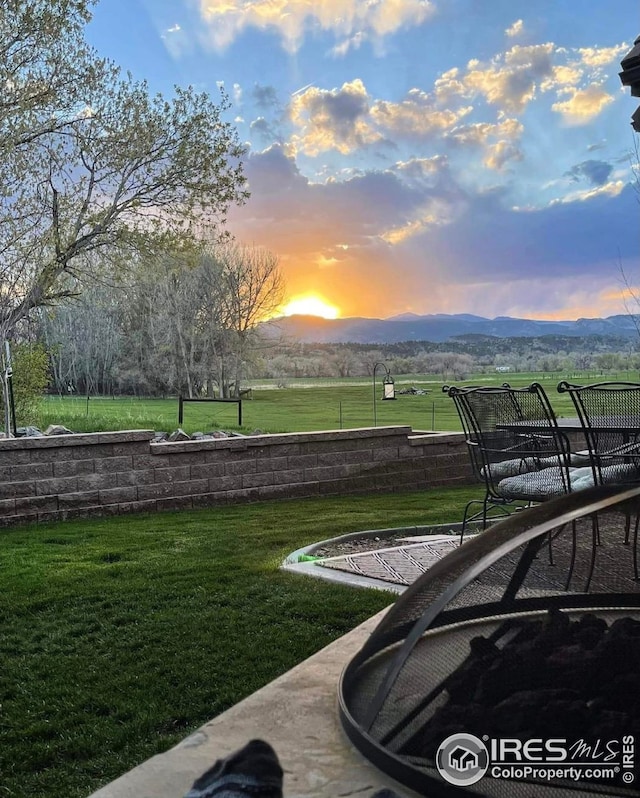 view of community with a lawn and a mountain view