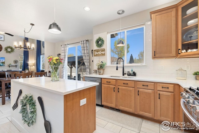kitchen with decorative backsplash, a center island, a sink, and appliances with stainless steel finishes